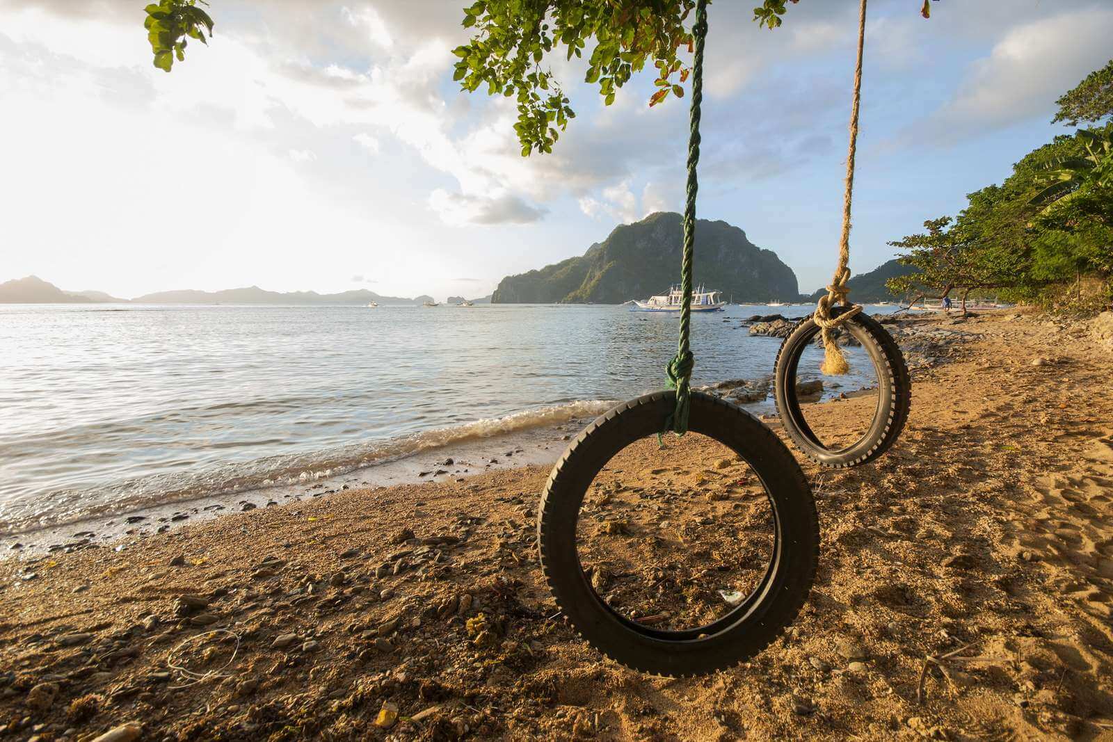 Swings made from old tires in Corong Corong Beach, El Nido