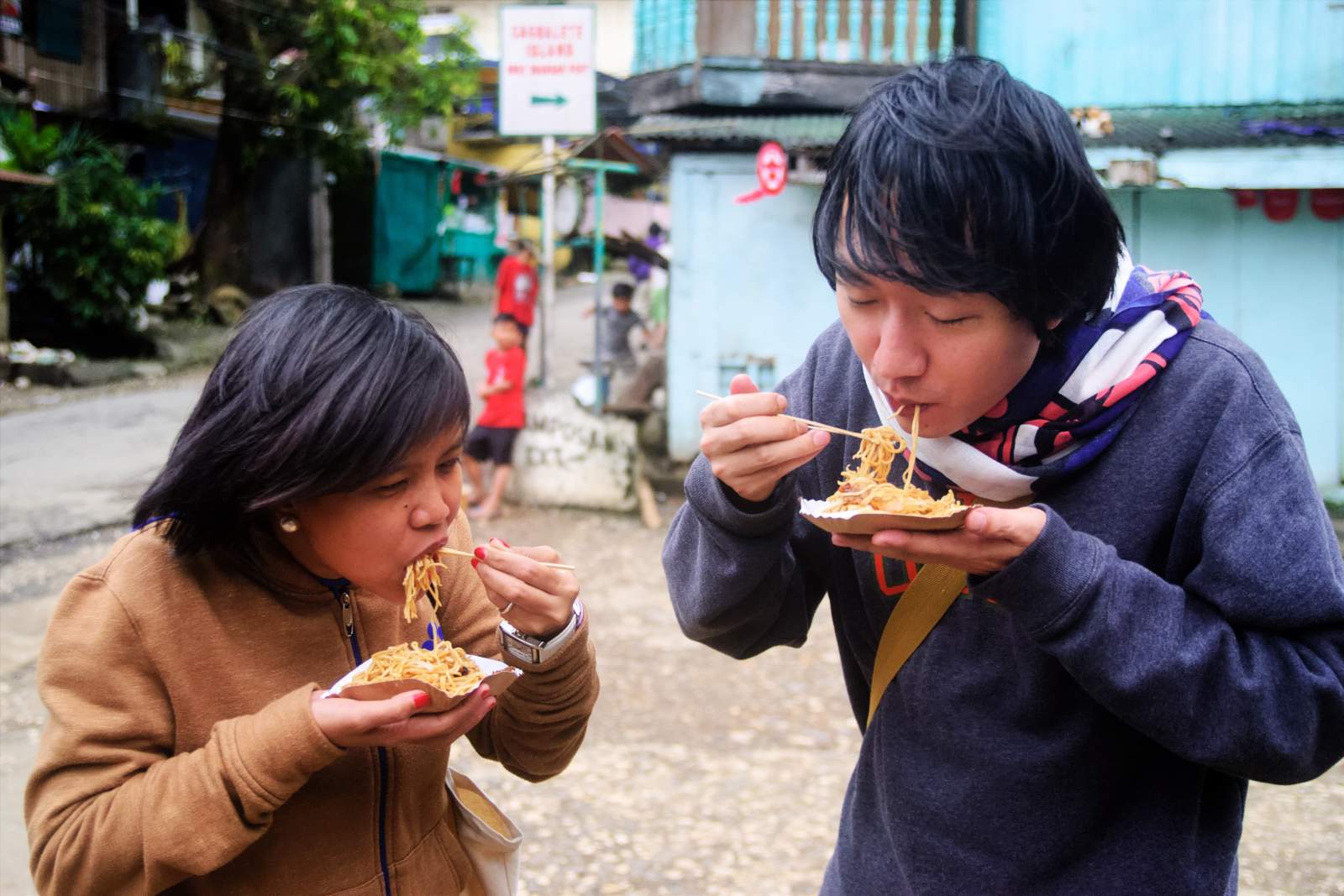 A couple of friends enjoying pancit habhab in Mauban